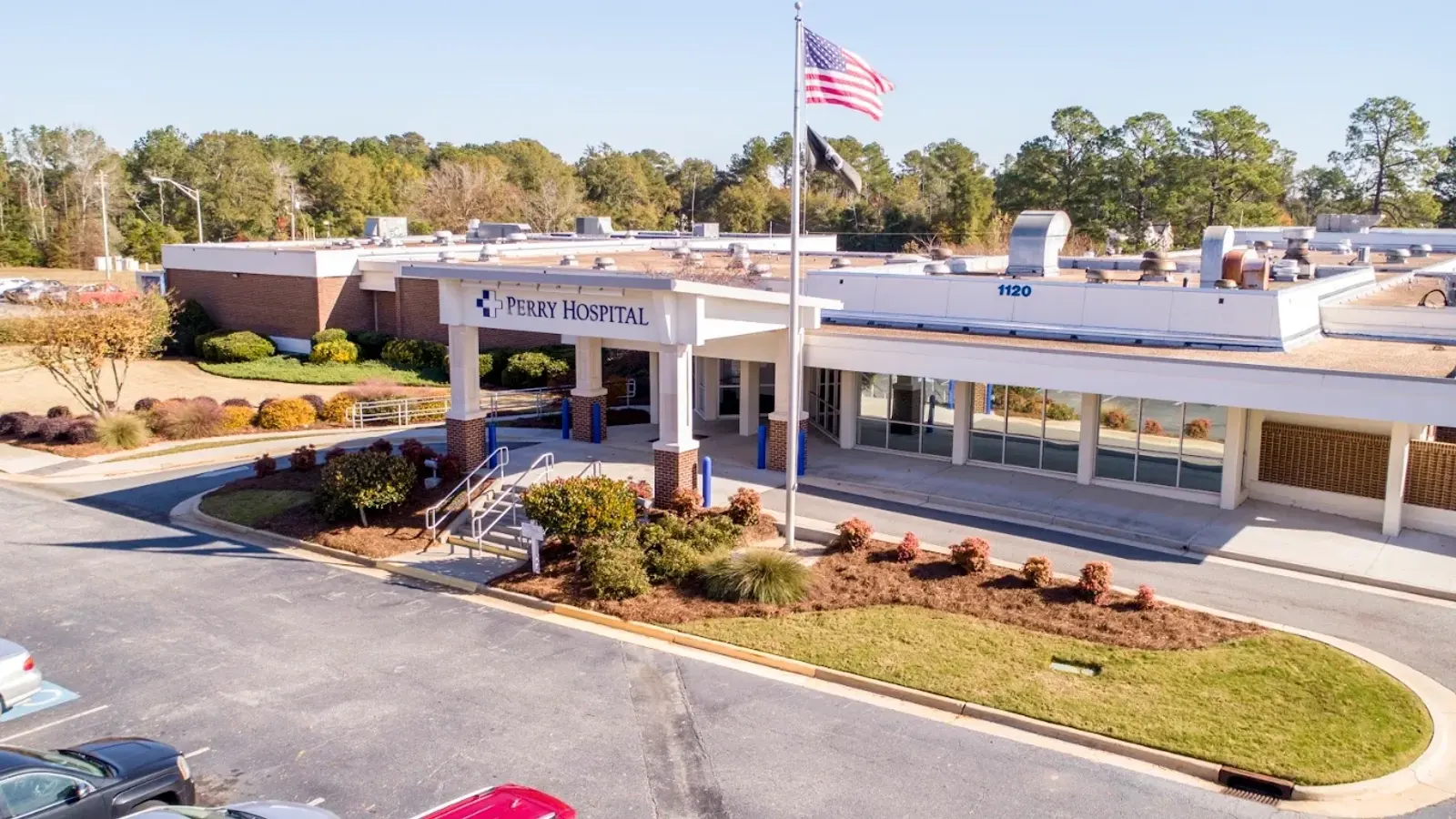 Perry Hospital main entrance canopy from above, flagpole and landscaped drive in front