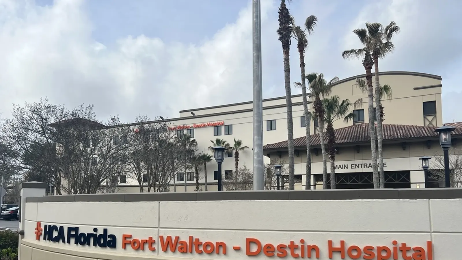 HCA Florida Fort Walton-Destin Hospital exterior sign with palm trees
