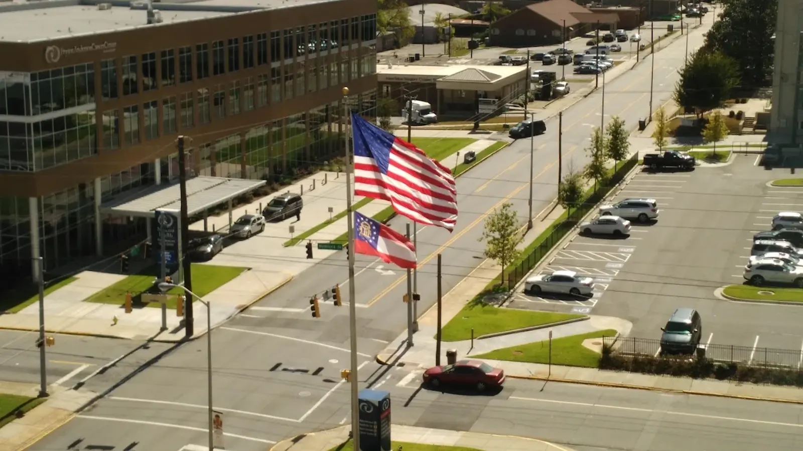 Coliseum Drive medical campus from above, American and Georgia flags in the foreground